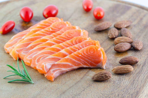 istock Salmon raw sashimi and Almonds with tomatoes on a wooden background 1125070377
