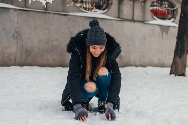 istock Cute woman making snowball 1125070716