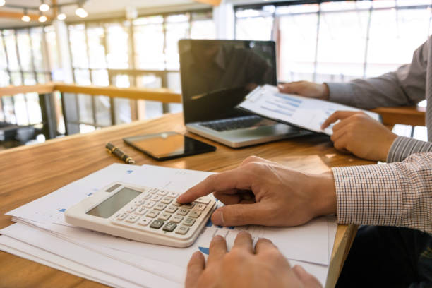 istock Business man analysis data document with accountant calculating about fee tax at a office 1125071198