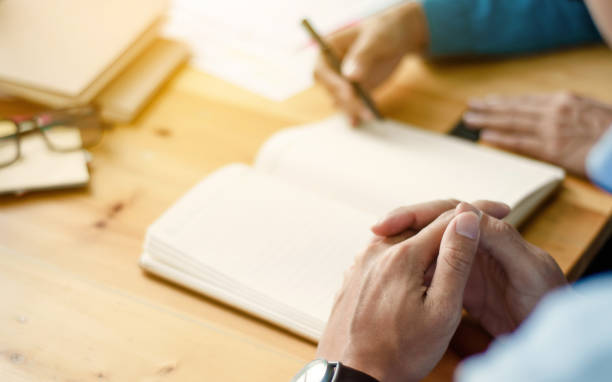 istock Two confident students doing homework together while sitting at the home or class room, selective focus 1125071206