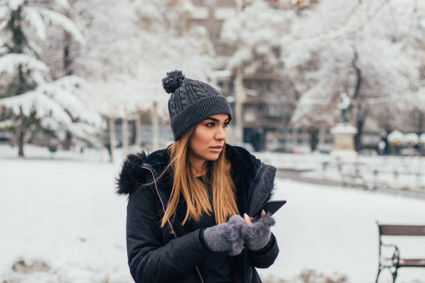 istock Elegant girl texting at the park 1125073088