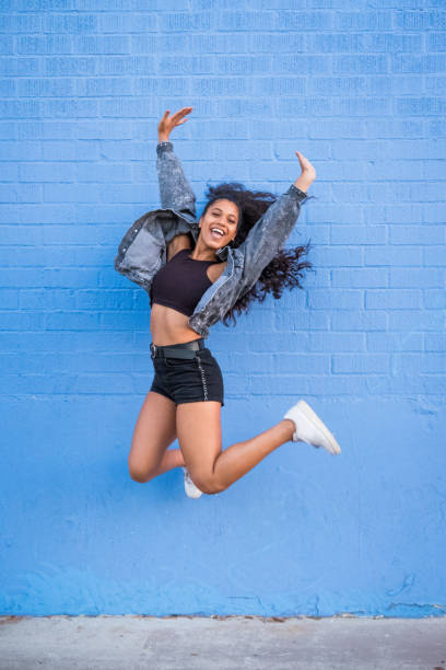istock African American Woman Against Blue Brick Wall 1125073491
