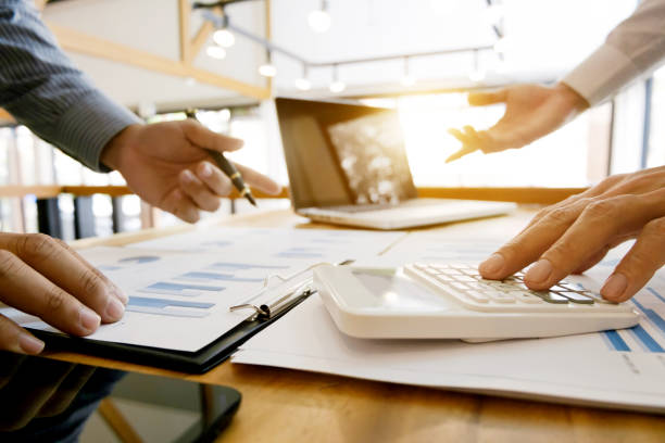 istock group of Business executives analysis data document and calculating about fee tax at a office 1125076032