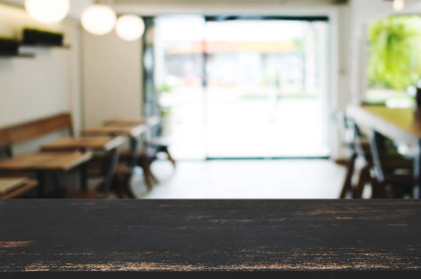 istock wooden table top in front of blur restaurant background. 1125076089