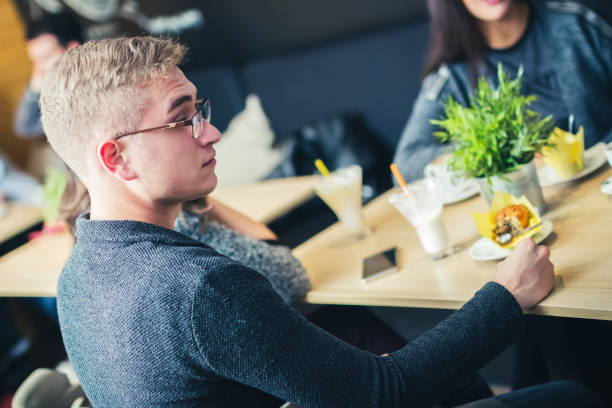 istock Young man relaxing with favorite coffee in cafe. 1125077920