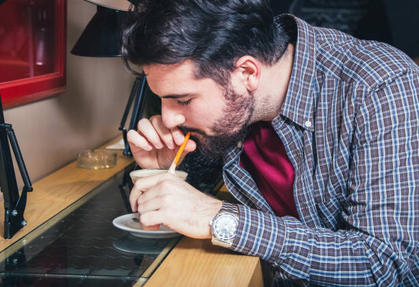 Young man relaxing with favorite coffee in cafe.