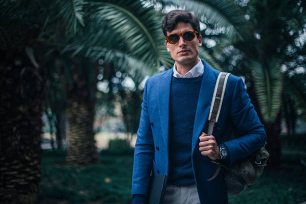 istock Stylish businessman walking in the park 1125079363