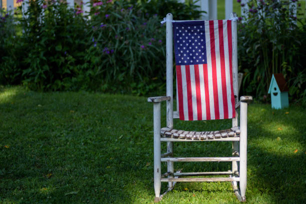 istock American flag hanging on old white rocking chair in backyard 1125084752