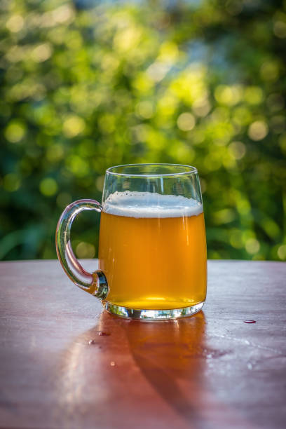 istock Glass mug of beer on table outside in summer 1125084901