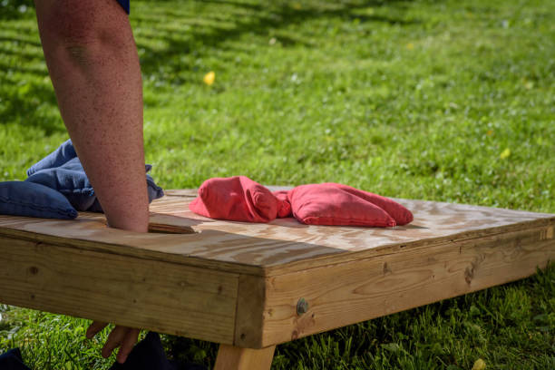 istock Man gabbing bag during corn hole game in summer 1125087364