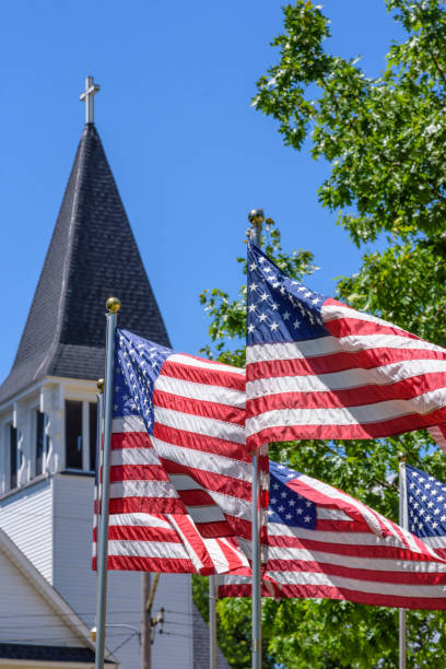 istock American flags waving outside white church 1125087967