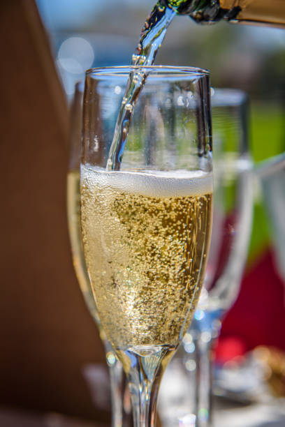 istock Pouring champagne in glass in sunlight 1125088064