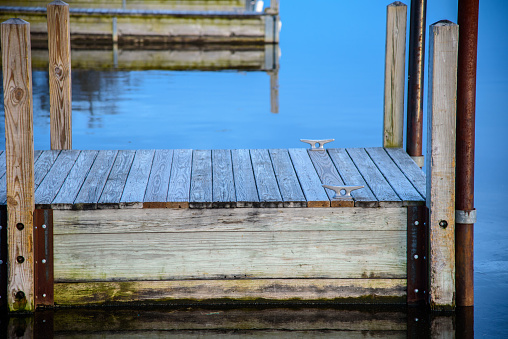 Low angle side view of wooden boat dock piers along boat ramps on lake