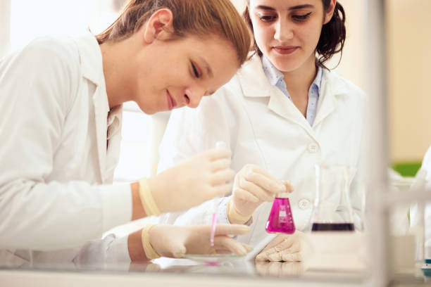Women Science Students in Research Practicing. Female Genetics Students Working in lab stock photo