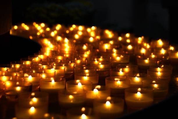 Candlelight Orange light of candles in the dark memorial vigil stock pictures, royalty-free photos & images