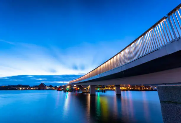 inderhavnsbroen or the cycle bridge connecting nyhavn to operahouse in Copenhagen Denamrk During early morning blue light