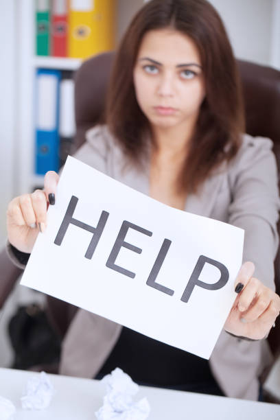 istock A Businesswoman Showing Help Flag At Workplace In Office 1125095808