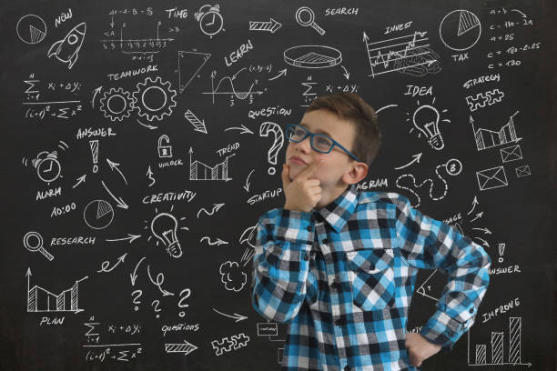 istock Young boy child think decision choice idea business strategy background blackboard 1125097934