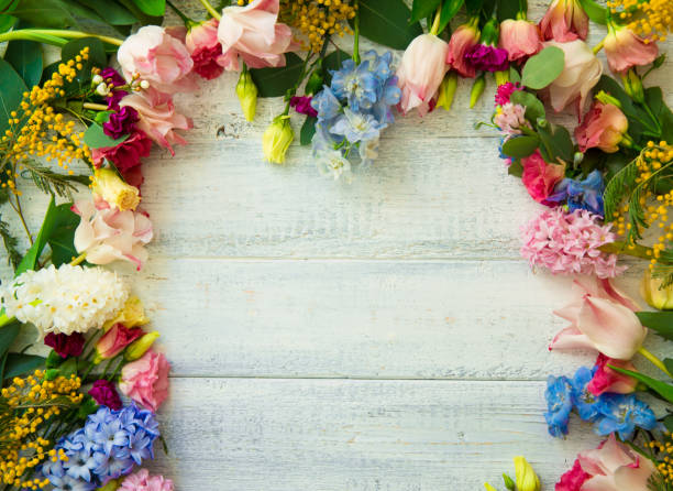 istock Spring flowers on wood background. Summer blooming border on a wooden table. 1125097962