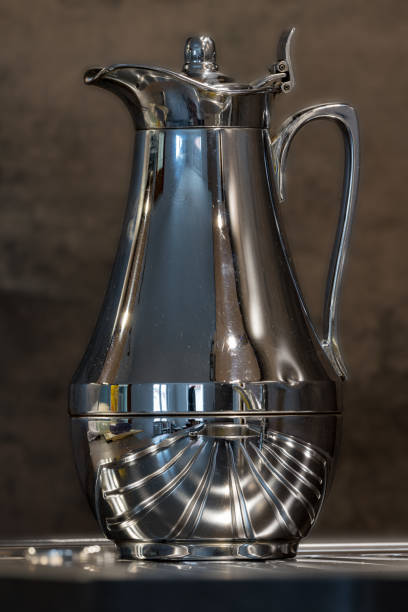 istock Shiny used coffee pot with strong reflections against a dark background 1125104379