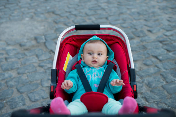 Little baby girl in stroller in the harbour Oldtown Antalya, Turkey