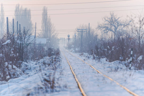 Tram rails. Foggy weather. Night fog. Poor visibility. Ray of light. Snow and ice. City street
