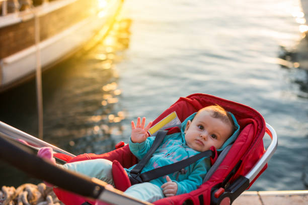 Little baby girl in stroller in the harbour Oldtown Antalya, Turkey