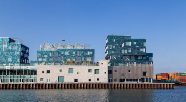 Amager Bakke, Slope or Copenhill, incineration plant, heat and power waste-to-energy plant and recreational facility in the district of Amager, Copenhagen, Denmark, with modern buildings and boats