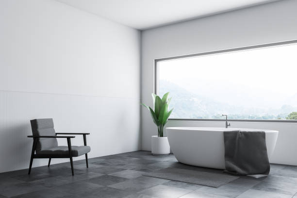 istock White bathroom corner tub and armchair 1125117074