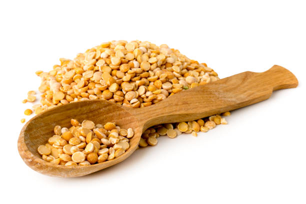 istock Dry yellow peas in wooden spoon on a white. 1125133610