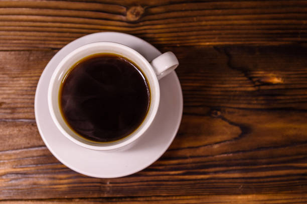 istock Cup of dark coffee on wooden table. Top view 1125135676