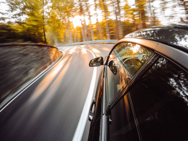 道路で車の長時間露光 - car winding road highway autumn ストックフォトと画像