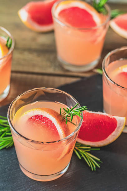 istock Fresh pink alcoholic cocktail with grapefruit, ice and rosemary 1125143134