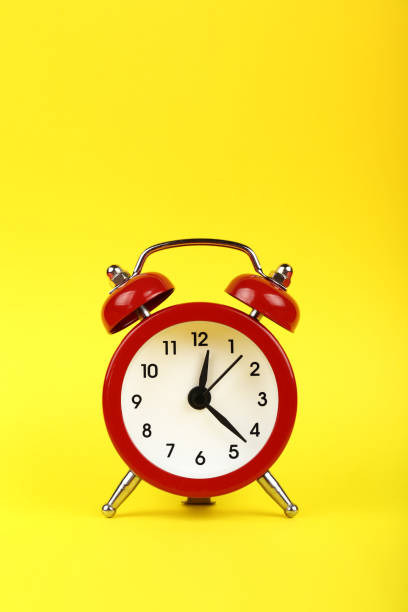 istock Close up one red alarm clock over yellow background 1125147497