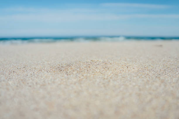 istock Close-up of sandy beach with blue sea 1125149330