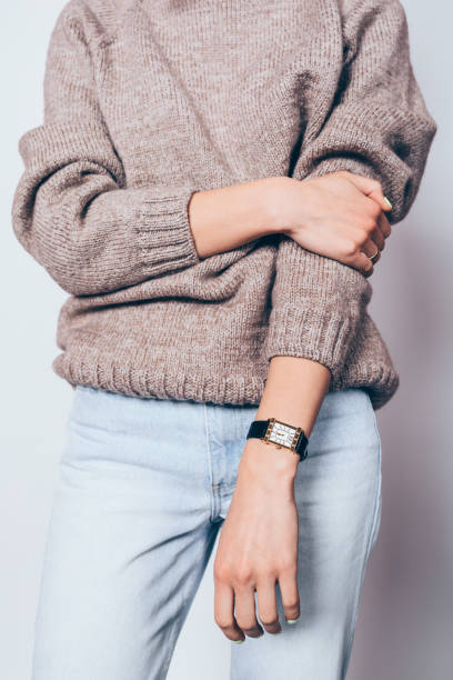 istock Stylish young woman wearing plain brown sweater 1125149389