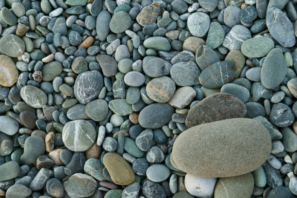 Round frame of small sea stones, isolated on white. Top view with copy space