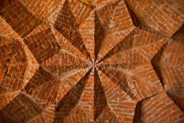 Symmetric, star shaped ceiling of an ancient cellar. Ancient architecture showing geometric shapes made of red bricks as construction material. Wide angle from directly below. XXXL (Canon Eos 1Ds Mark III)