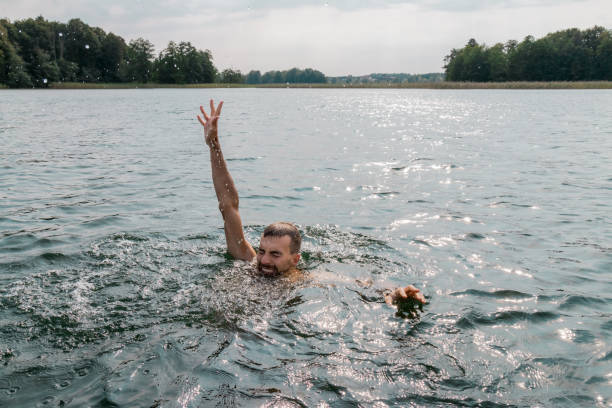 istock Drowning man. Sticking hand out of water. 1125150968