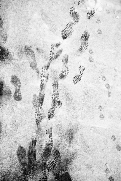 istock Shoe prints on winter snowy road 1125155600