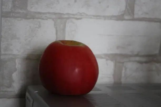 red apple on white wall