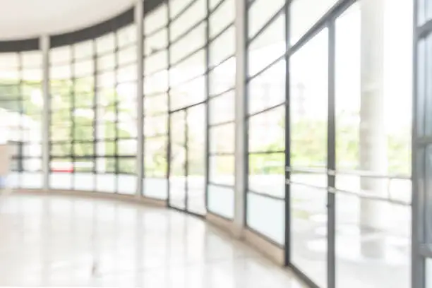 Photo of Blur background interior view looking out toward to empty office lobby and entrance doors and glass curtain wall