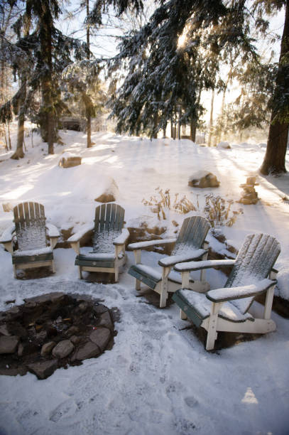 istock Adirondack chairs covered in snow near a fire pit 1125181218