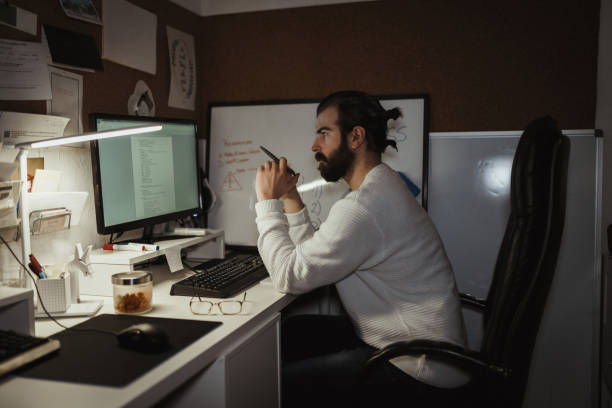 istock Young man working late night at the home office 1125183906