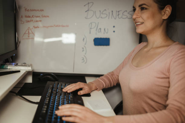 istock Smiling woman working late and using computer at the home office 1125184403