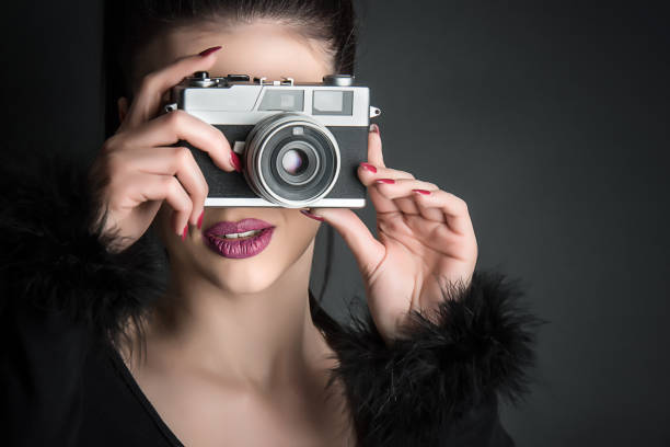 istock Girl with a retro camera 1125190152