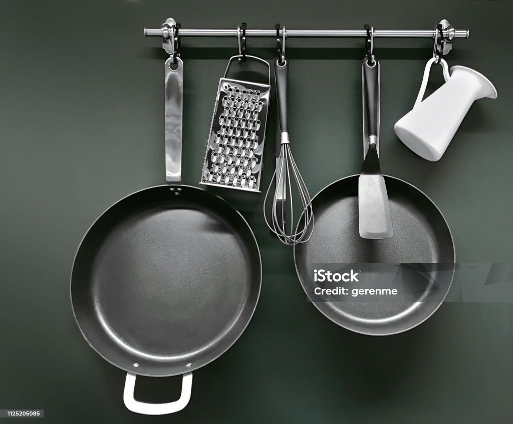 Cooking utensils Cooking utensils hanging on a pot rack Cooking Pan Stock Photo