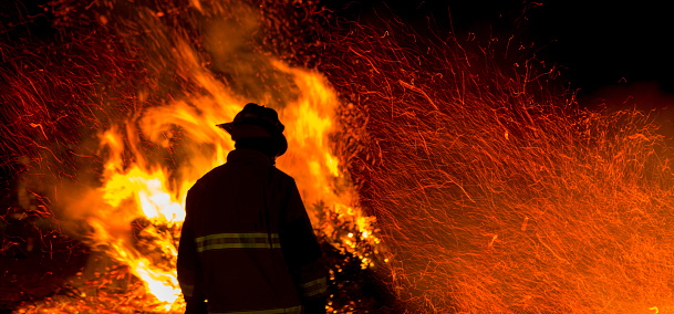 Firefighter watches a controlled burn