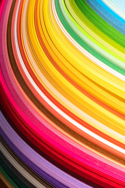 Papers of various colors are placed on top of each other creating an abstract sequence