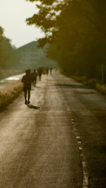 istock Blurred man is jogging on street among the sun light 1125212272